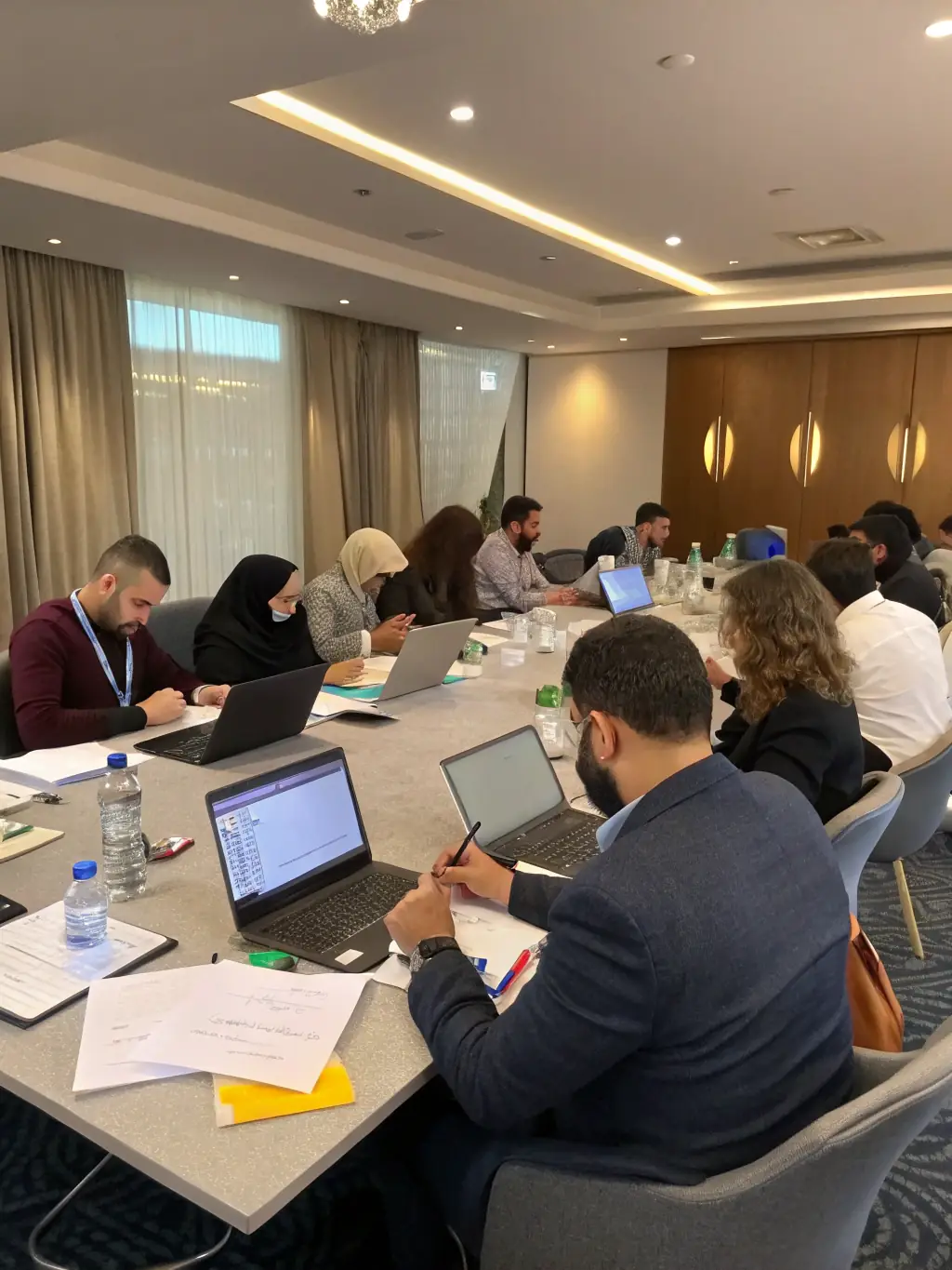 A photograph depicting a group of employees actively participating in a workshop session, with a focus on hands-on learning and collaboration.